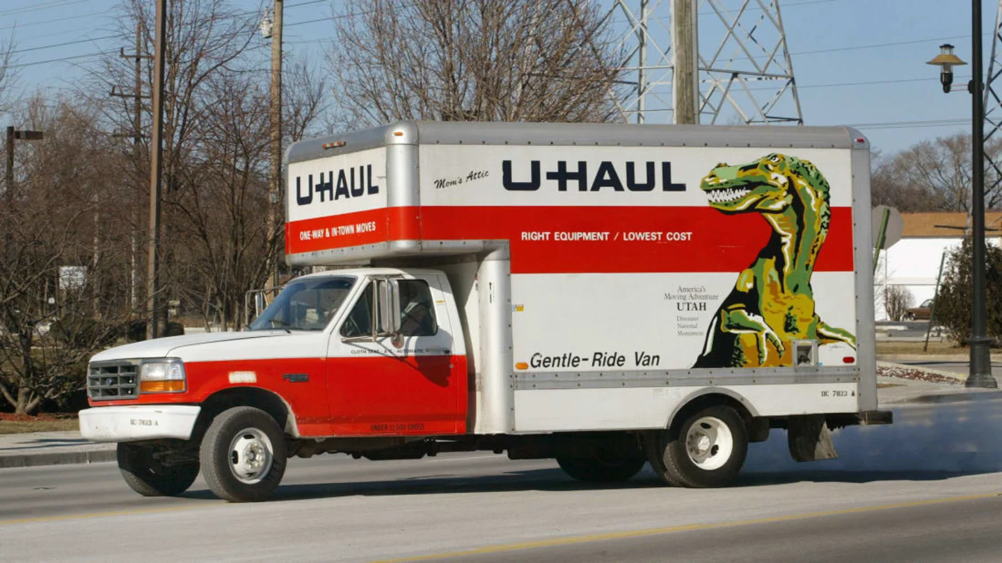 A u-haul truck is parked on the side of the road.