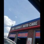 A car parked in front of a building with the words " free service auto care ".