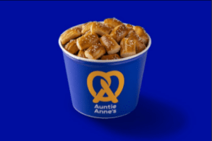 A blue bucket of pretzels on top of a table.
