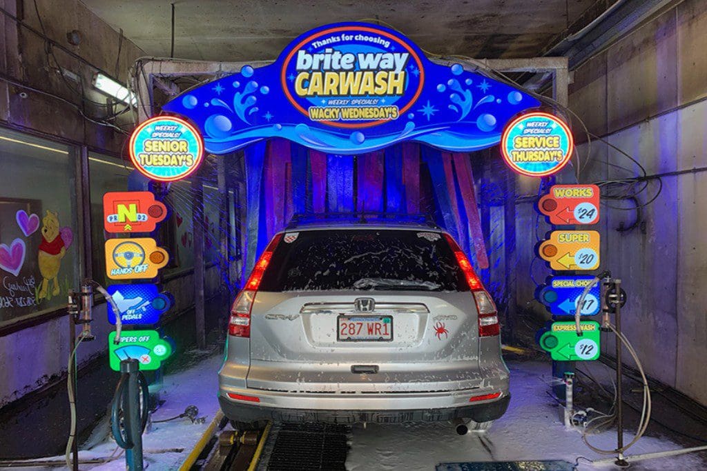 A car wash with a silver car in it