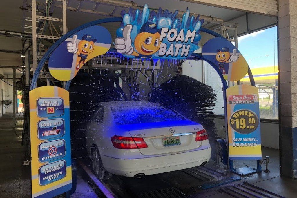A car is being washed in the foam bath.