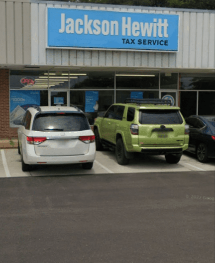 Two cars parked in a parking lot next to each other.