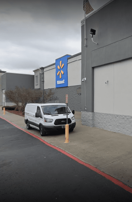 A van parked in front of a store.