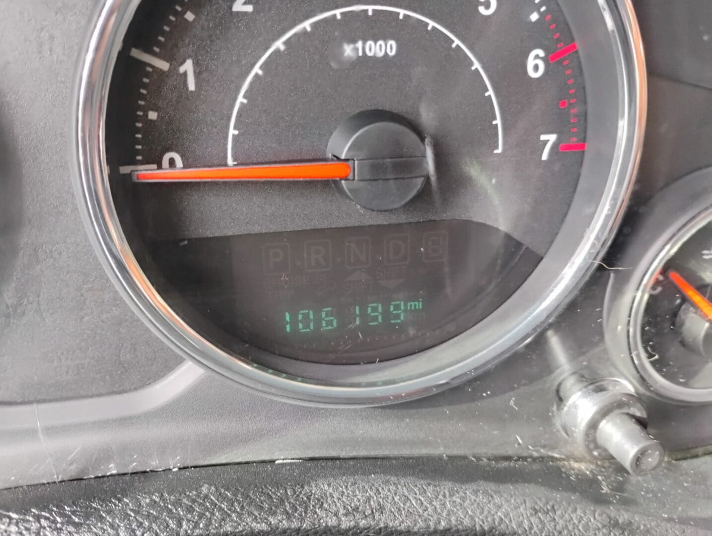Car odometer showing 106,816 miles.