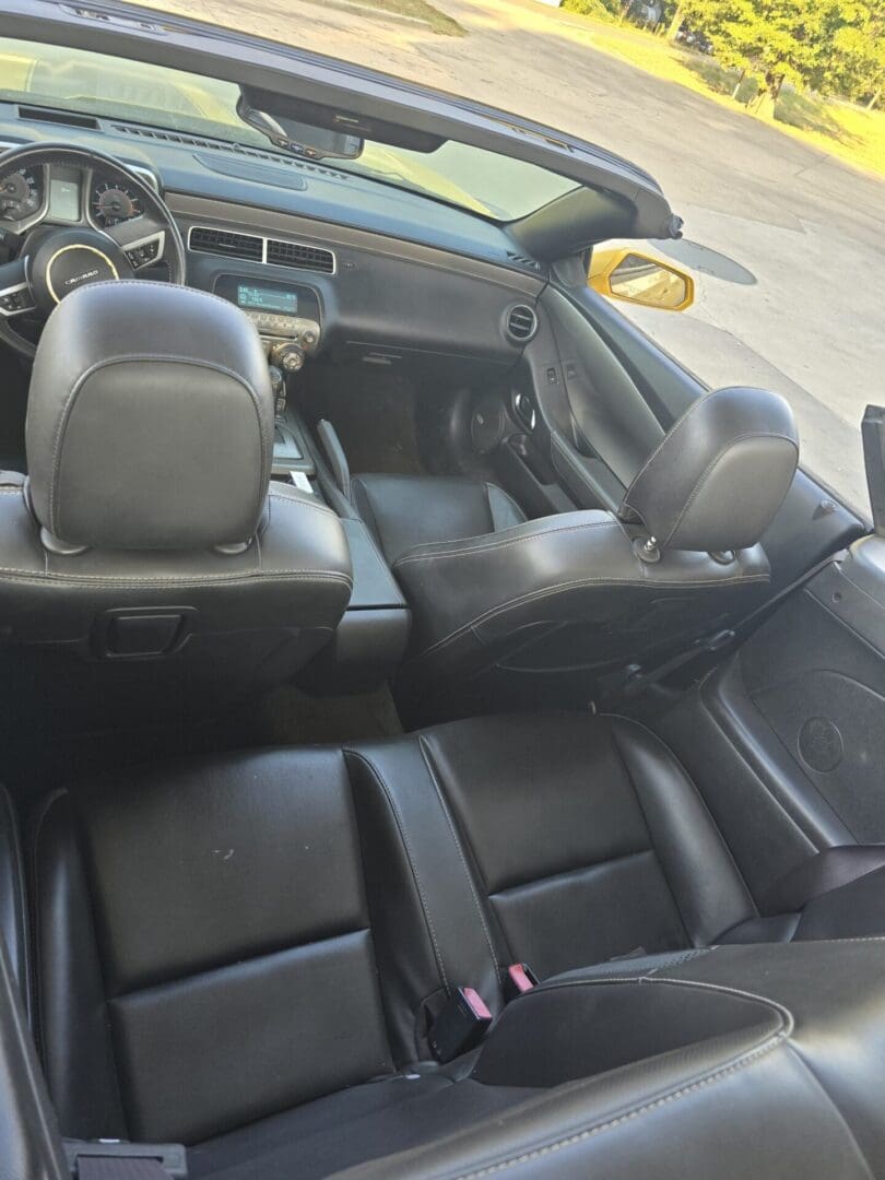 Interior view of a car with leather seats and dashboard.