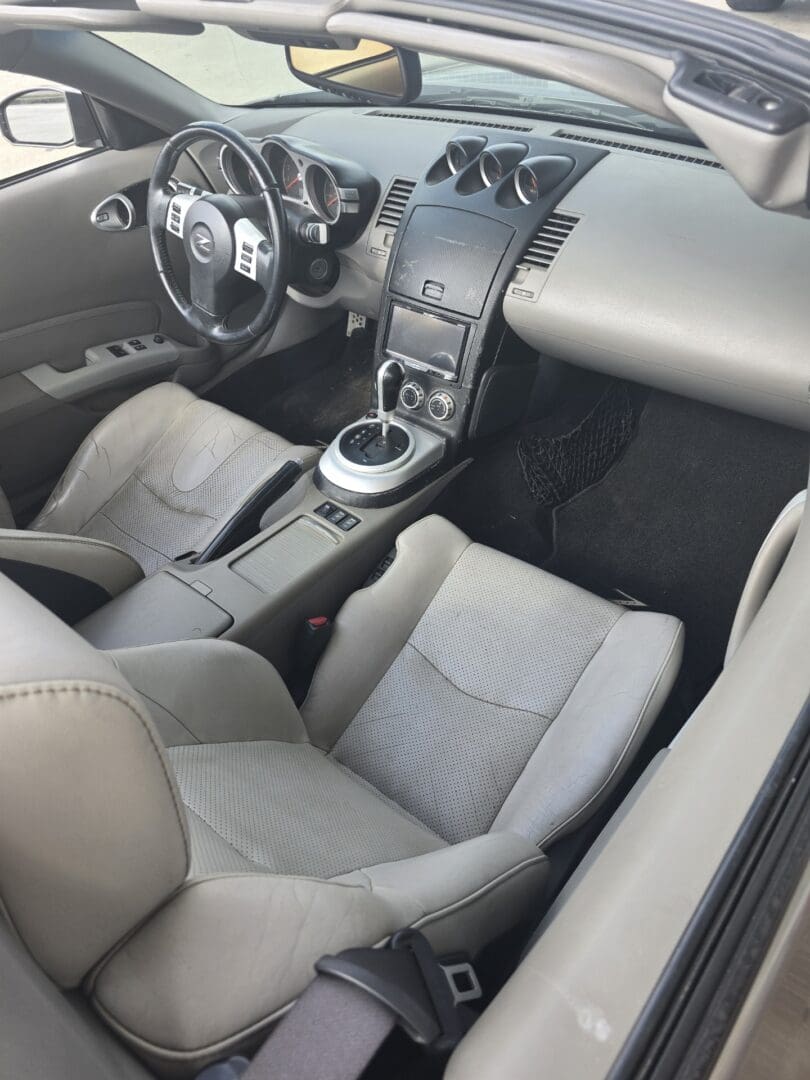 Clean, modern car interior with gray seats and central console.