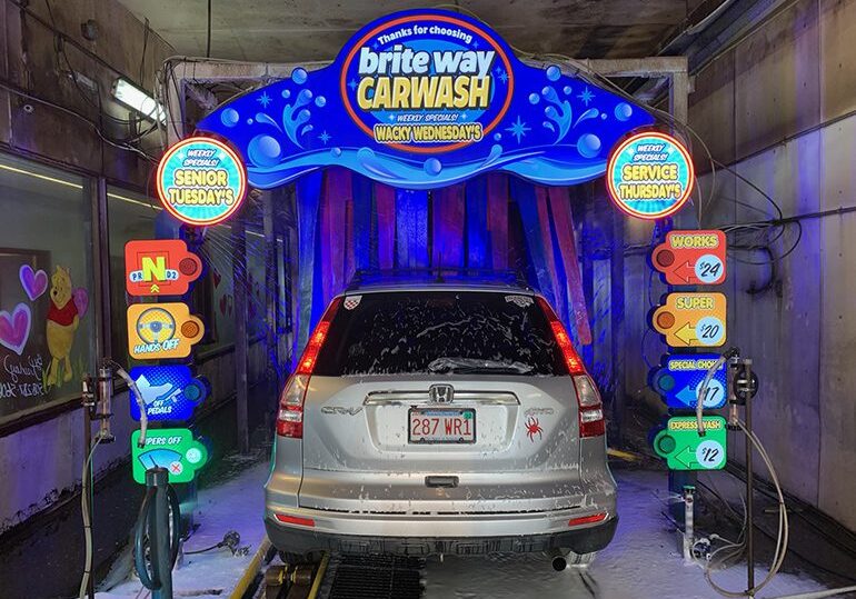 A car wash with a silver car in it